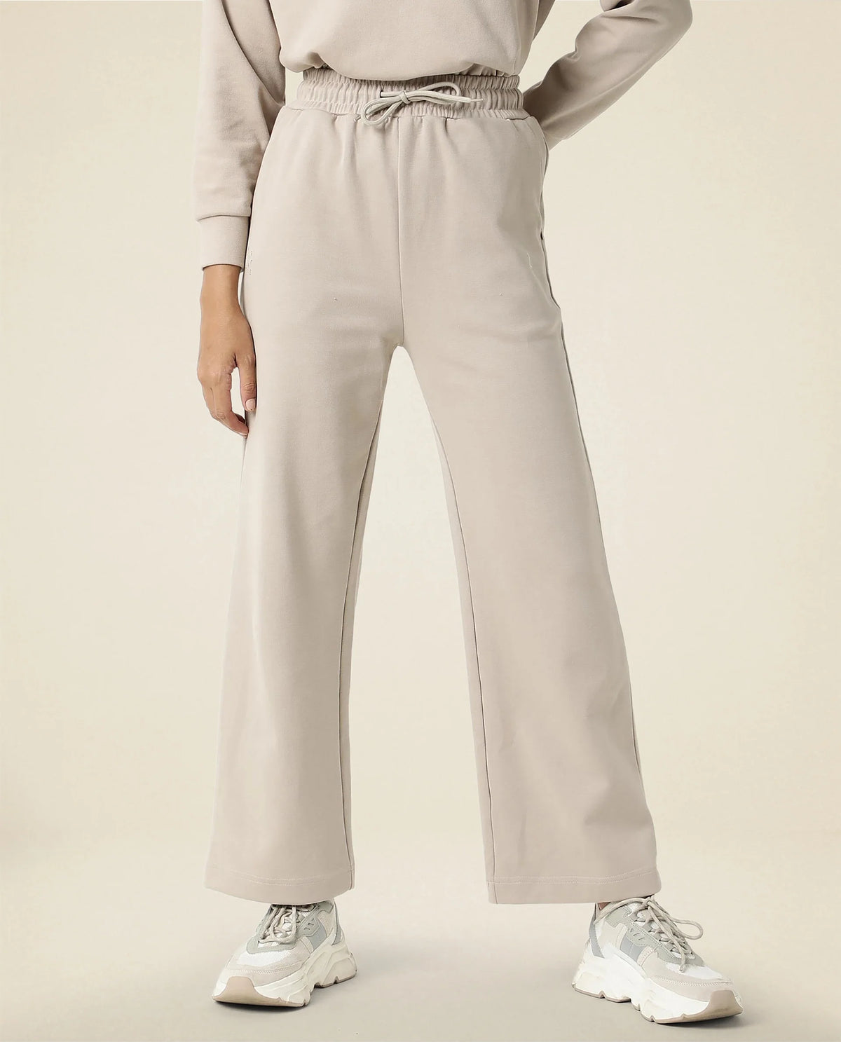 Rareism Women Capsule Beige Cotton Blend Fabric Relaxed Fit Solid Mid Rise Ankle Length Track Pant
