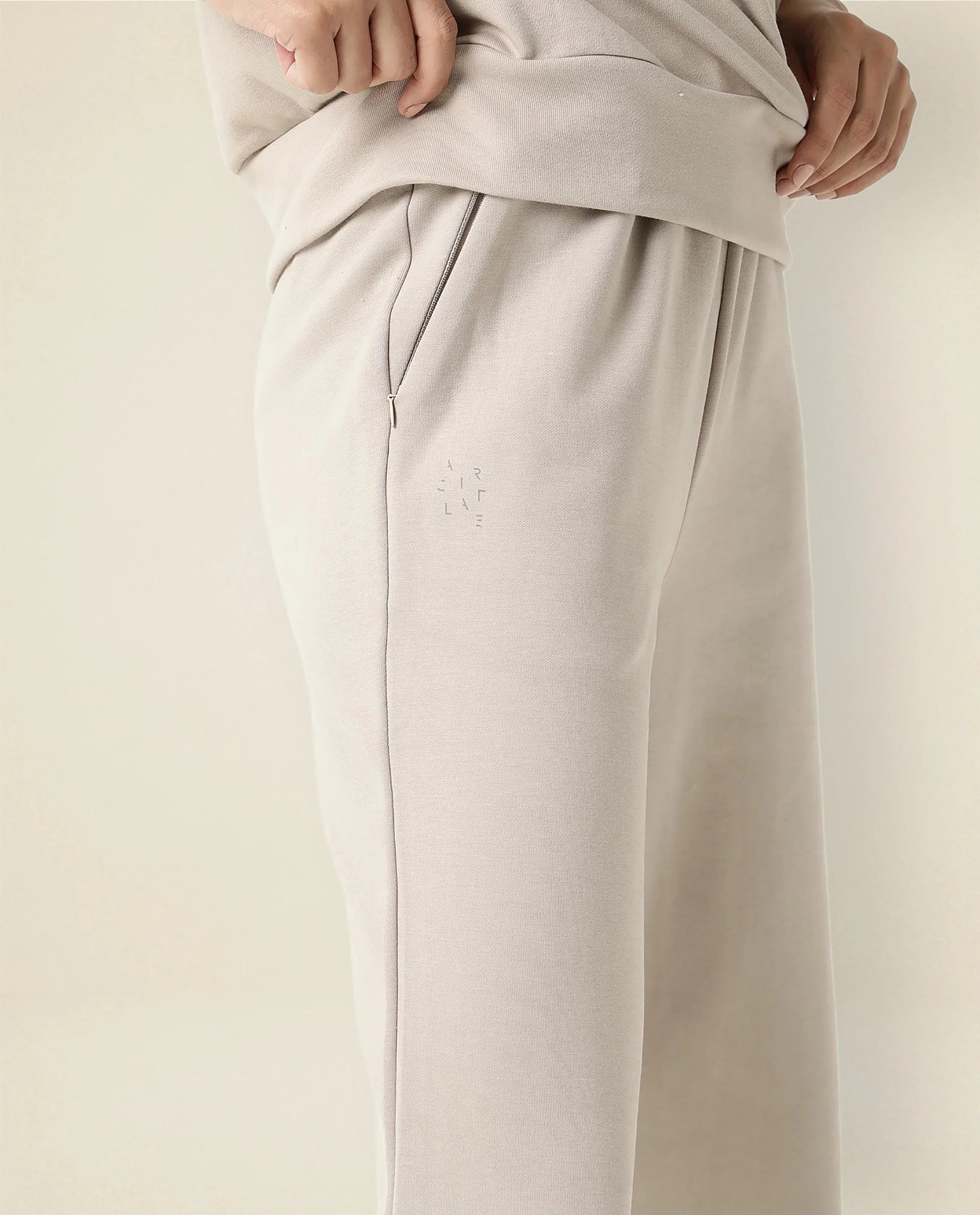 Rareism Women Capsule Beige Cotton Blend Fabric Relaxed Fit Solid Mid Rise Ankle Length Track Pant