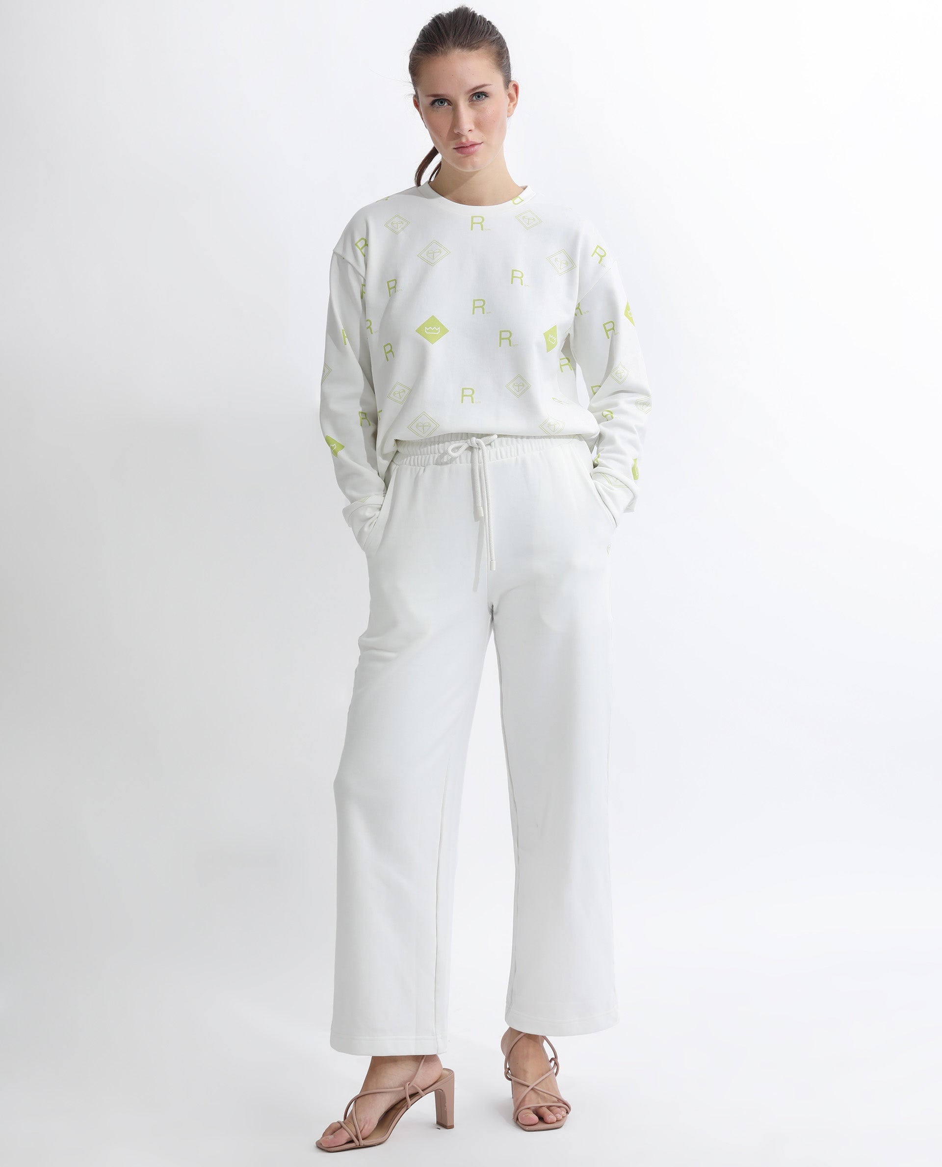 Rareism Women Pazoo T Off White Cotton Blend Fabric Flared Solid Mid Rise Ankle Length Track Pant