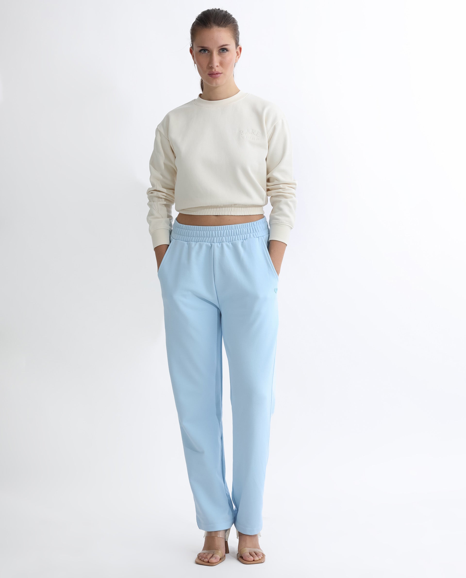 Rareism Women Fronk Light Blue Poly Cotton Fabric Tailored Fit Solid Mid Rise Ankle Length Track Pant