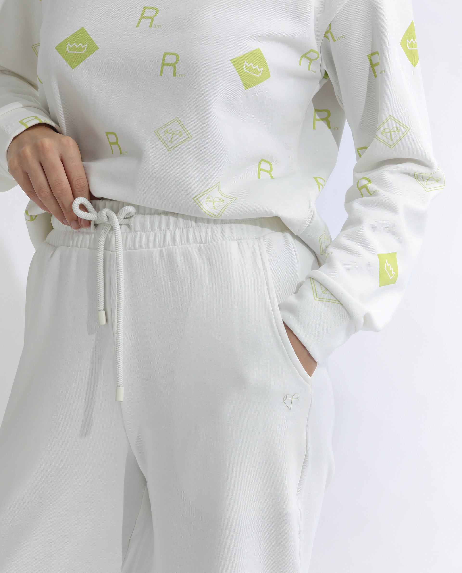 Rareism Women Pazoo T Off White Cotton Blend Fabric Flared Solid Mid Rise Ankle Length Track Pant